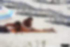 Topless milf and her topless daughter on the beach