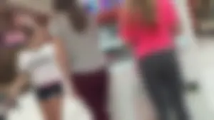 Little blonde teen in grey leggings at the mall with her friends