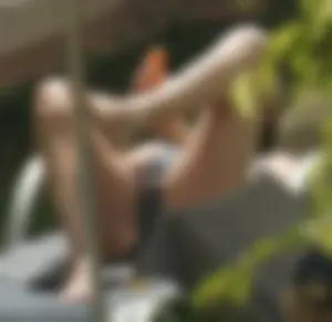 Skinny girl laying out in her bikini has pussy lip slip