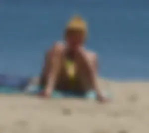 Sexy ass blonde milf on the beach in a thong with cameltoe and bending over