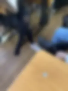 College Candid Teen in Pantyhose And a Skirt Putting On Her Sneakers in Classroom