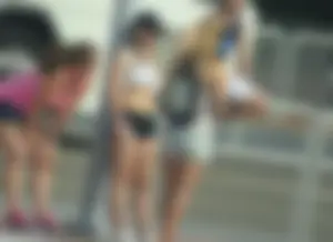 Couple of babes standing around in shorts