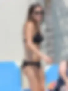 Sexy girl at the pool in a black bikini with nice body