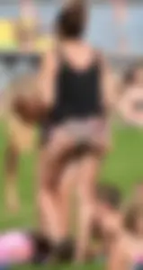 Sexy blonde girl in the park playing volleyball in her skimpy bikini