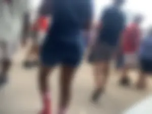 Bunch of girls in various outfits at a Cardinals baseball game