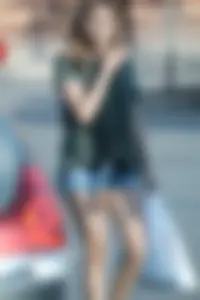 Cutie walking in the parking lot in jean shorts