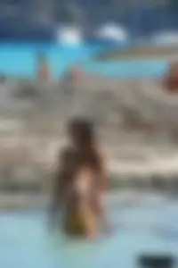 Nude beach ladies in the water showing their tits