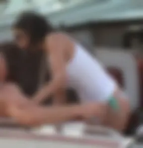 Bikini babe on a boat with a wet see through white shirt showing her tits