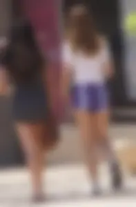 Sexy teen with glasses showing ass cheeks in shorts and friend in tight dress