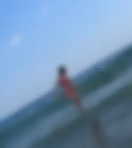 Sexy girl at the beach in a red thong bikini with nice tits and ass