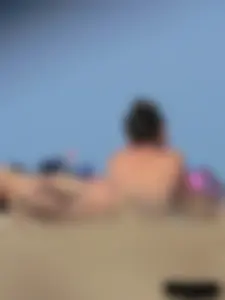 Sexy babe with a nice body topless and in a thong on the beach