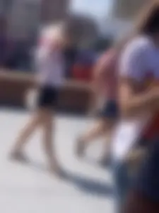 Bunch of girls in various outfits at a Cardinals baseball game