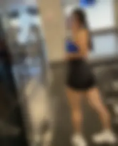 Awesome Muscly Girl in a Sport Top And Spandex Shorts Taking a Mirror Selfie at the Gym