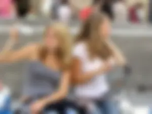 Two girls showing some of their panties while sitting