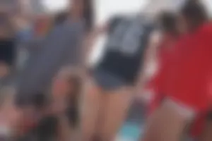 A group of teens in bikinis on the beach