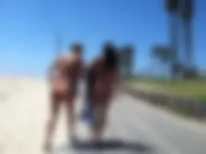 Two sexy girls with nice asses in bikinis walking on a beach trail