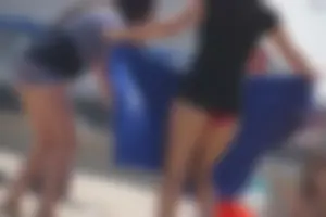 A group of teens in bikinis on the beach