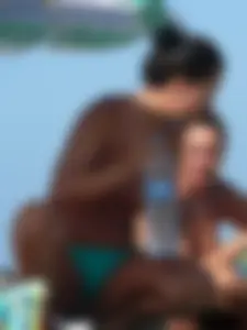 Bunch of sexy babes on the beach topless and in thong bikinis