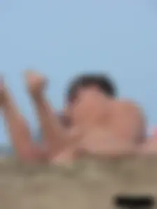 Sexy babe with a nice body topless and in a thong on the beach