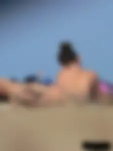 Sexy babe with a nice body topless and in a thong on the beach