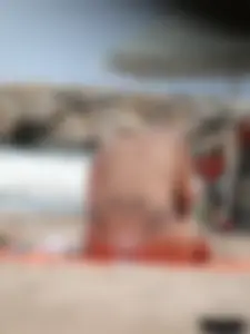 Tattooed blonde with big tits topless and in thong