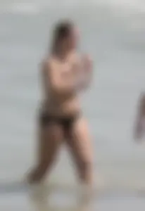 Big boobed thick blonde on the beach in a bikini