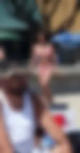 Sexy brunette on the beach in a bikini with great tits