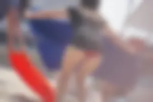 A group of teens in bikinis on the beach