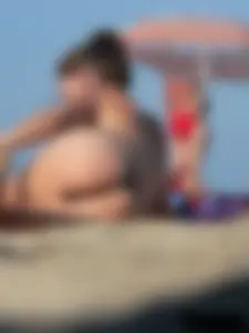 Sexy babe with a nice body topless and in a thong on the beach