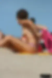 2 topless girls at the beach in thongs