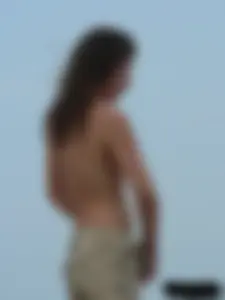 Sexy babe with a nice body topless and in a thong on the beach