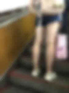 Candid Girl in Denim Shorts and Sneakers Standing on the Escalator - Hot Legs Closeups