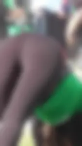 Sexy brunette in see thru leggings stretching before a run with a green thong