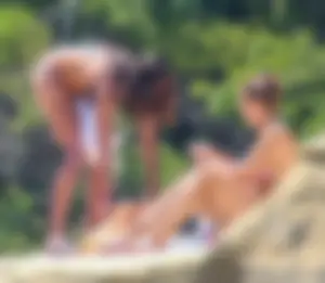 Group of sexy friends at the beach in bikinis