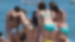 Bunch of sexy babes at the beach in bikinis
