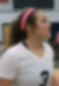 Bunch of cute college girls in bright pink shorts playing volleyball