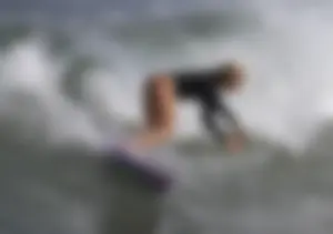 Blonde Surfer Girl in a One-Piece Swimsuit Photo Gallery