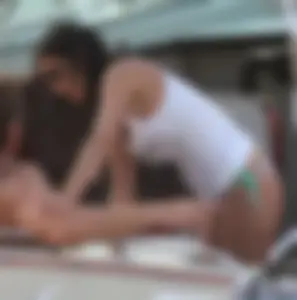 Bikini babe on a boat with a wet see through white shirt showing her tits