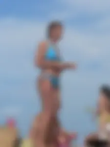 Sexy lady on the beach in a blue thong bikini