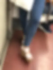Candid girl wearing tight blue jeans and sandals on high platforms