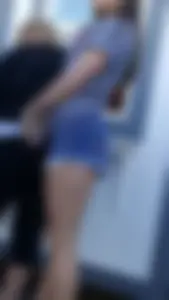 Brunette teen jean shorts in line