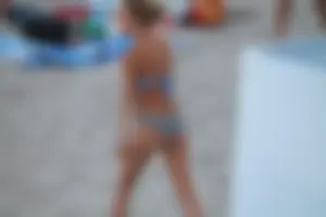 Sexy girl playing beach volleyball in a bikini