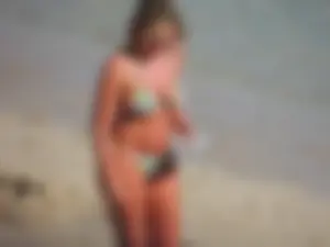 Blonde milf on the beach in her bikini