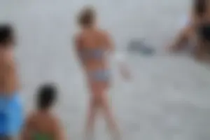 Sexy girl playing beach volleyball in a bikini