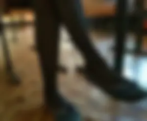 Crossed Legs in Black Pantyhose and Flats Under Desk in College Classroom Closeups