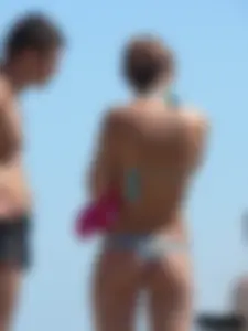 A bunch of hot babes on the beach in thong bikinis