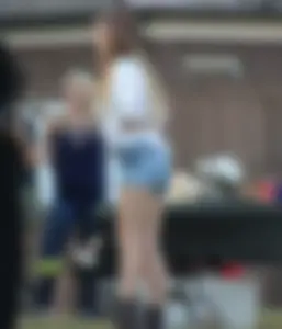 Hippie type dressed girl in denim shorts with a nice ass