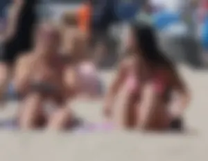 Sexy brunette on the beach in a bikini with great tits