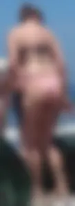Chunky beach blonde babe in a pink thong bikini