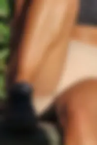 Tanned fitness woman showing off her toned physique & amazing butt